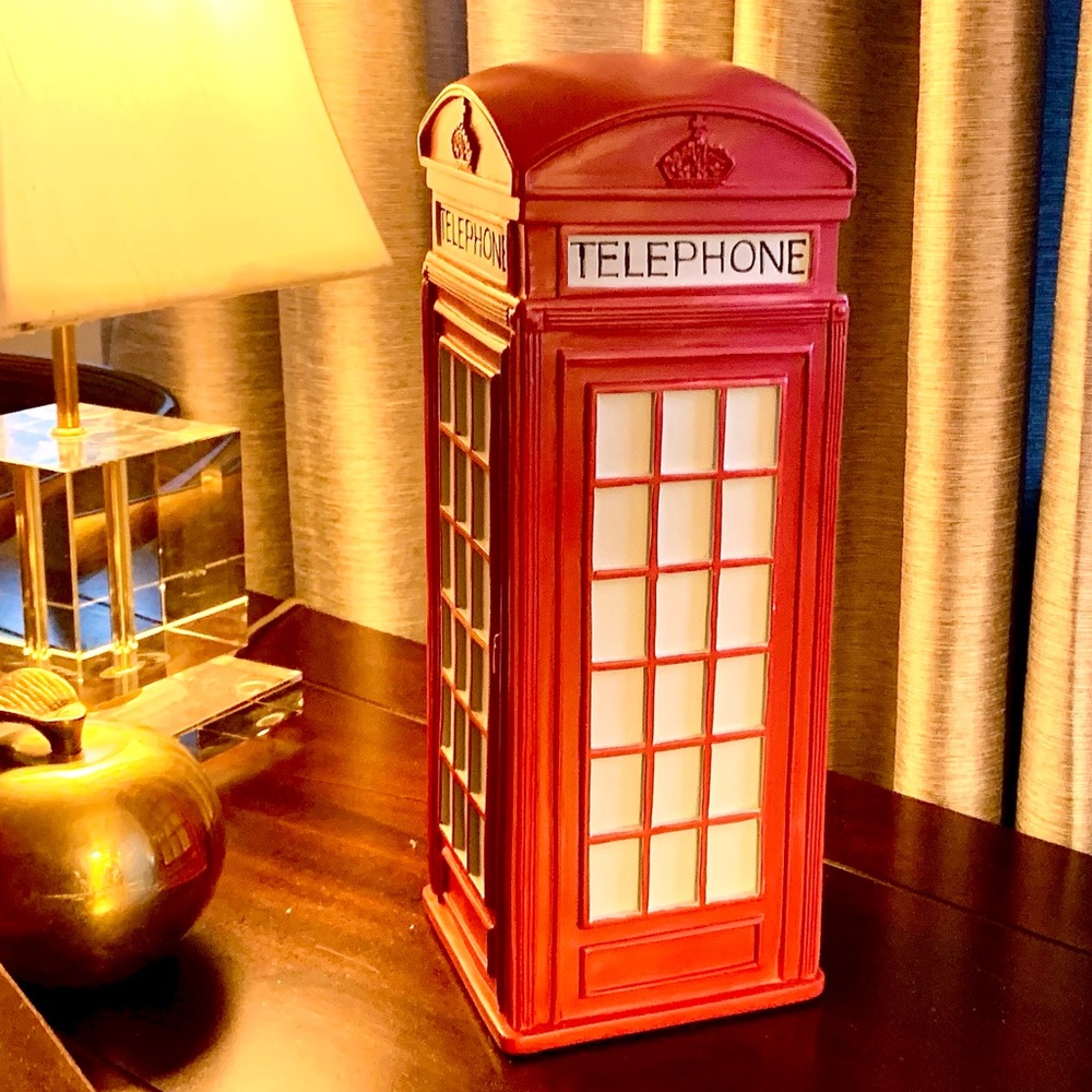 Retro style classic red British phone booth in London.
